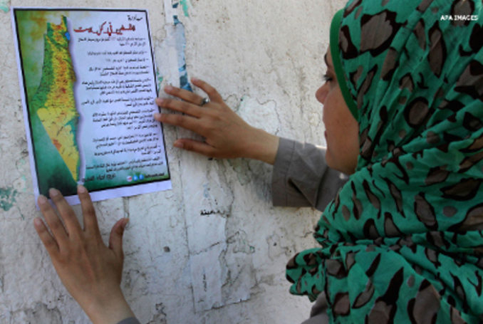 Une Palestinienne tient une carte de la Palestine historique - Photo : Mohammed Asad